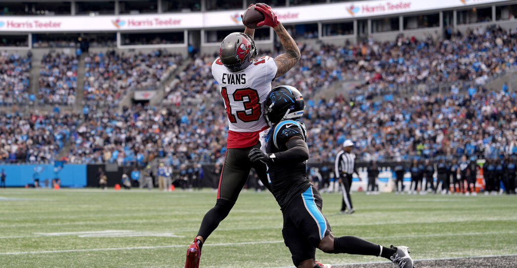 Dec 21, 2025; Charlotte, North Carolina, USA; Tampa Bay Buccaneers wide receiver Mike Evans (13) catches a touchdown against Carolina Panthers cornerback Mike Jackson (2) during the first half at Bank of America Stadium. Mandatory Credit: Jim Dedmon-Imagn Images